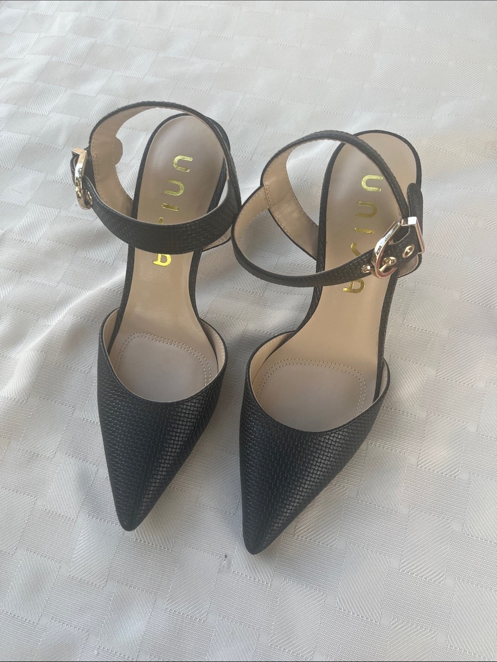 Unisa Black Pointed-Toe Ankle Strap Heels with Gold Buckle